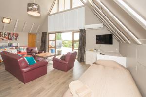 a bedroom with a bed and a living room at Riverfields in Ashburton