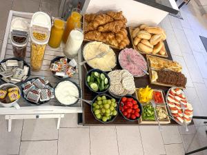 a table with many different types of food on it at Clown and Bard Hostel in Prague