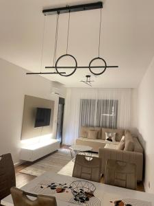 a living room with a couch and a chandelier at Bliss by the Sea in Ulcinj