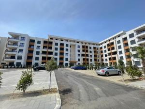 a parking lot in front of a large apartment building at Bliss by the Sea in Ulcinj