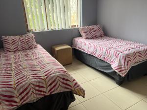 a bedroom with two beds and a window at Prime Leisure in Margate