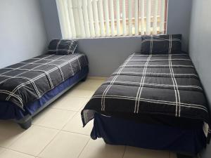 a bedroom with two beds and a window at Prime Leisure in Margate