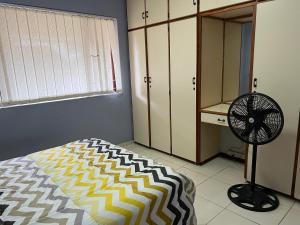 a bedroom with a bed and a fan in it at Prime Leisure in Margate