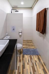 a bathroom with a toilet and a sink at The Strand Resort Samui in Bangrak Beach