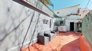 a group of chairs sitting on the side of a building at Apartaments Segur Kandy 1 in Calafell