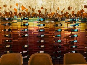 a room with a wall of wine racks at Le Petit Manoir Boutique Hotel in Franschhoek
