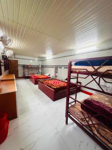 a large room with three bunk beds in it at MSP Amma Cottage in Munnar