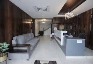 a living room with a couch and a counter at Nandha Grande in Udumalaippettai