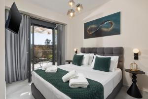 a bedroom with two beds and a balcony at Villa Kouros P&A in Áfra +39 photos