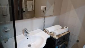 a bathroom with a sink and a washing machine at Saburtalo VIP in Tbilisi City