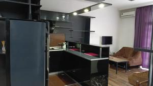a kitchen with a black counter in a room at Saburtalo VIP in Tbilisi City
