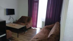 a living room with a couch and a table at Saburtalo VIP in Tbilisi City
