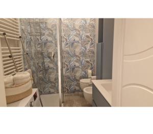a bathroom with a shower with a toilet and a sink at Castelli di sabbia in Levanto +23 photos