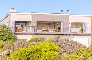 a large white house with a balcony at Whales Rest in Pearly Beach