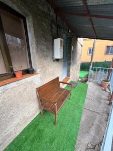 a wooden bench sitting on a patch of green grass at Casa Villafeile in Villafeile