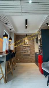 a restaurant with a bar with a sign on the wall at VOYAGE CUBIC Adults Only in Sibiu