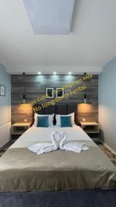 a bedroom with a large bed with a bow on it at VOYAGE CUBIC Adults Only in Sibiu