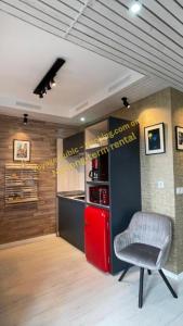 a kitchen with a red refrigerator and a chair at VOYAGE CUBIC Adults Only in Sibiu