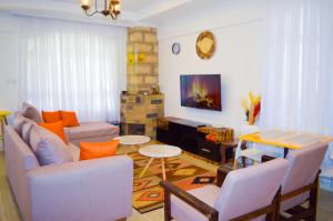 a living room with a couch and a table at Olkeleo HummingBird Cottage in Naivasha