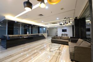 a large living room with couches and a bar at StarRay Hotel Jakarta Mangga Dua Square in Jakarta