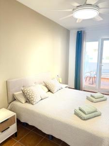 two beds in a bedroom with a view of the ocean at Heavenly Homes Mojacar 75 in Mojácar +36 photos