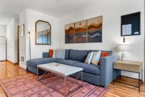 a living room with a blue couch and a table at 08 Lodge in Hood River