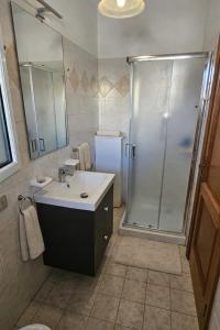 a bathroom with a sink and a shower at Rosa Fronte Mare in Torre Mozza