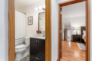 a bathroom with a toilet and a sink and a mirror at 08 Lodge in Hood River +20 photos
