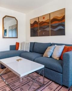 a living room with a blue couch and a table at 08 Lodge in Hood River