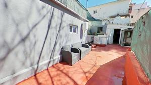 a group of chairs sitting on the side of a building at Apartaments Kandy 2 in Calafell +9 photos