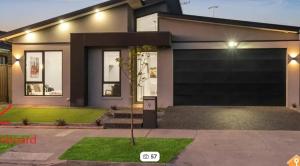 a house with a large garage at Cozy Private Room Family Home Close to Airport in Donnybrook