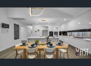 a kitchen and dining room with a table and chairs at Cozy Private Room Family Home Close to Airport in Donnybrook