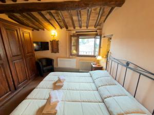 a bedroom with a large bed in a room at Le Torri View Apartment - San Gimignano in San Gimignano +8 photos