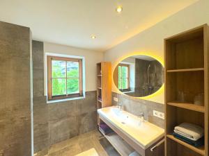 a bathroom with a sink and a mirror at Apartments Golfweg in Kitzbühel +70 photos