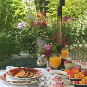 a table with a plate of food and glasses of orange juice at Green Oasis Lodges in Harare