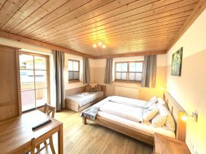 a bedroom with a bed and a desk in it at Apartments Golfweg in Kitzbühel