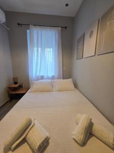 a bedroom with two beds with towels on them at SeDi Cozy Apartment in Chios