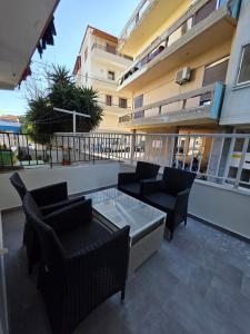 a patio with chairs and a table on a building at SeDi Cozy Apartment in Chios