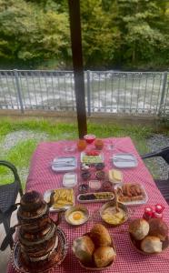 a picnic table with bread and pastries on it at Lahza Tiny House in Çamlıhemşin +7 photos