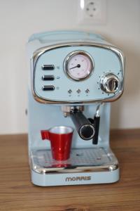 a coffee maker with a cup on top of it at Villa Noema Kineta in Kineta
