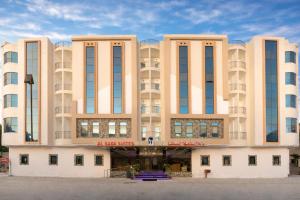 a building in front of a parking lot at Elsafa Hotel in Salalah