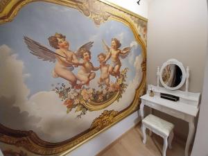 a mural of angels on a wall in a bathroom at Un Air de Poudlard in Bogny Sur Meuse