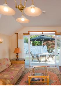 a living room with a couch and a table with an umbrella at Seaport Village in Russell