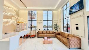 a living room with two couches and a tv at Mandhata Riverview Palace in Mortakka