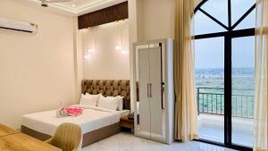 a hotel room with a bed and a balcony at Mandhata Riverview Palace in Mortakka +165 photos