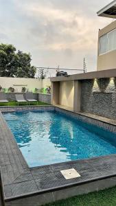 a large blue swimming pool in front of a building at Paradise View Apartment in Gatunga