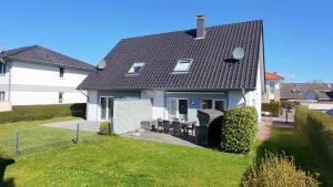 a white house with a black roof at 1006 - Haus Seesternweg in Dahme