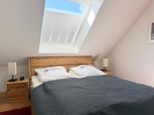 a bedroom with a bed with two pillows and a window at 1006 - Haus Seesternweg in Dahme