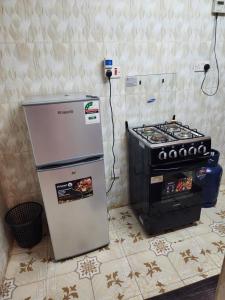 a refrigerator and a stove in a kitchen at Pure excellence homes in Ruiru +24 photos