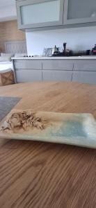 a plastic tray on a wooden table with water in it at The Gallery on Gray in Knysna +33 photos